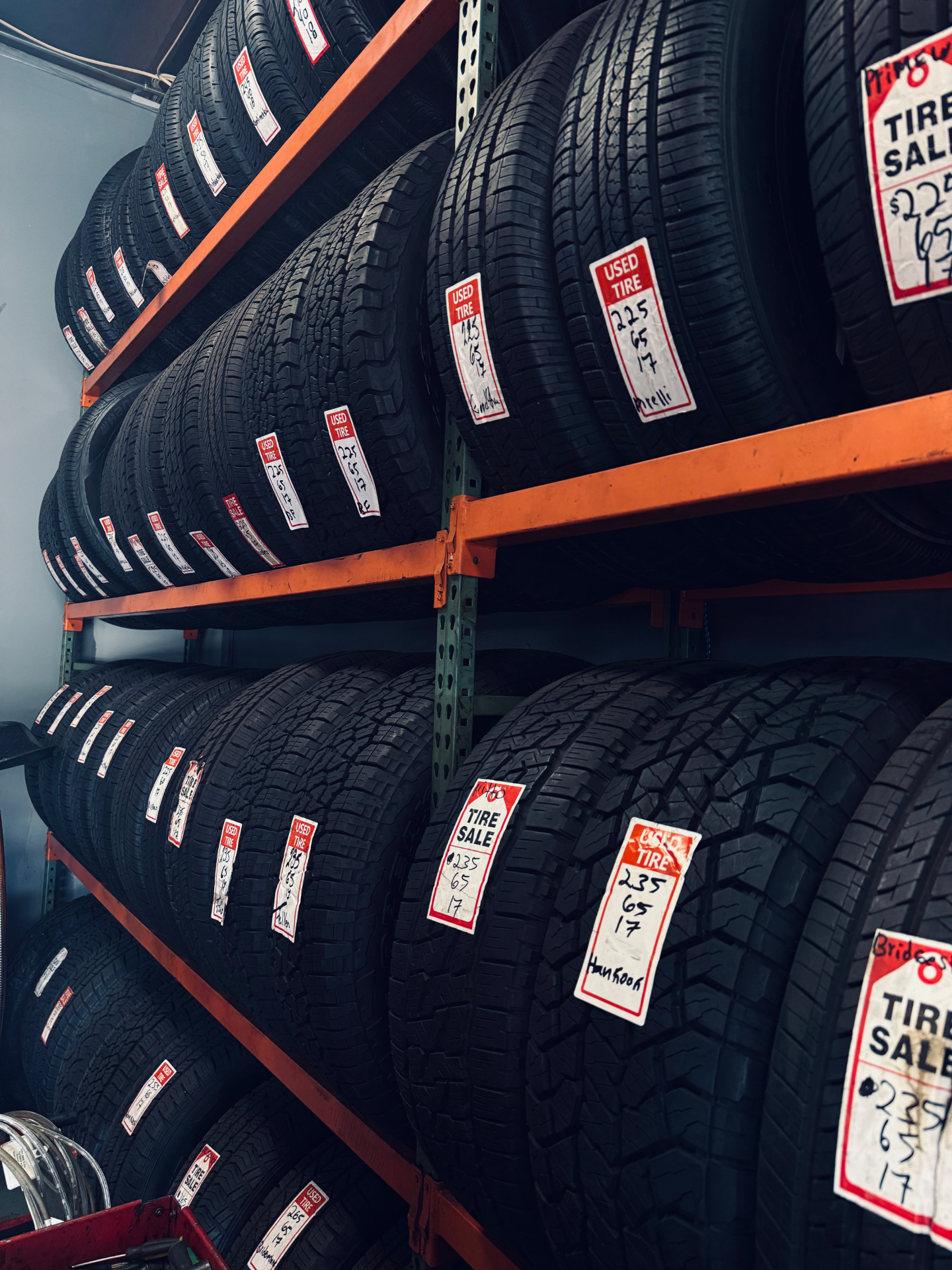 Wall of new and used tires in stock at Tires 4 Less